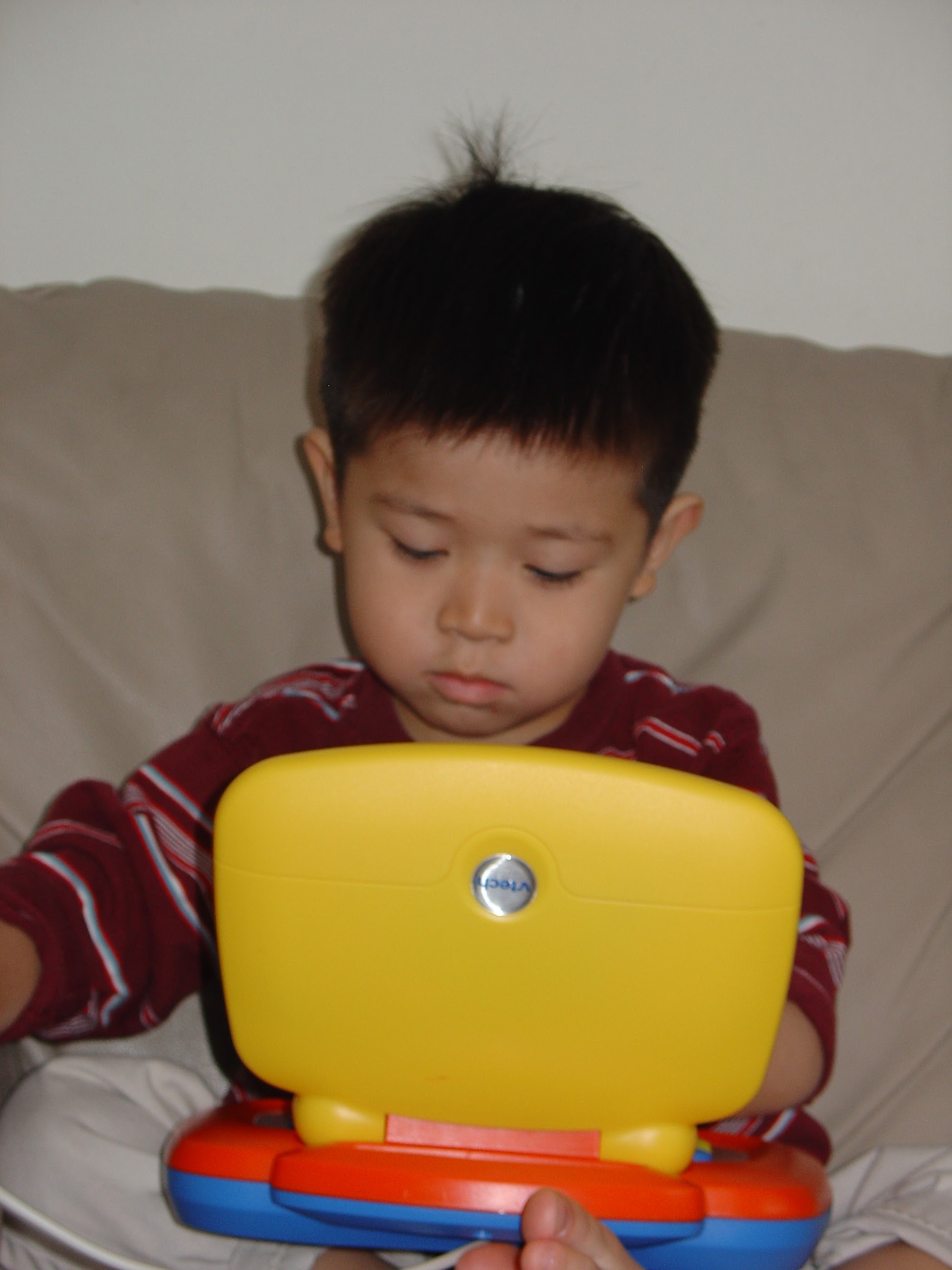 William Nguyen as a baby holding a toy computer